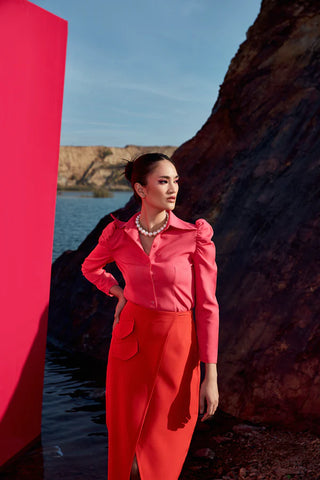 Cailo Gigot Pink Blouse Paired with a Vibrant Red Skirt