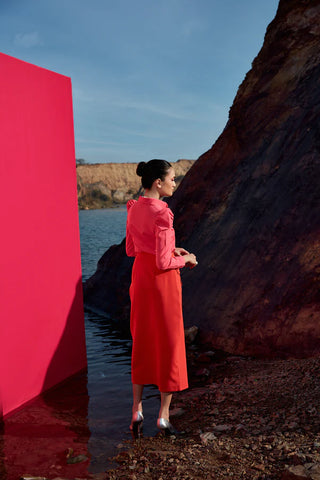 Cailo Gigot Pink Blouse Paired with a Vibrant Red Skirt